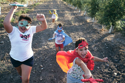 Children run around pretending to be superheroes and fight demons