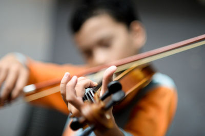 Defocused image of boy playing violin