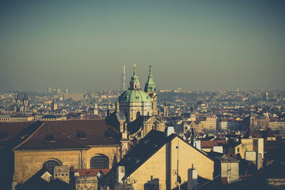 Aerial view of city buildings against clear sky