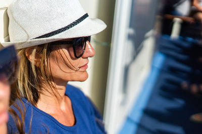 Close-up of woman wearing hat in boat