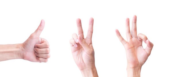 Close-up of hands against white background