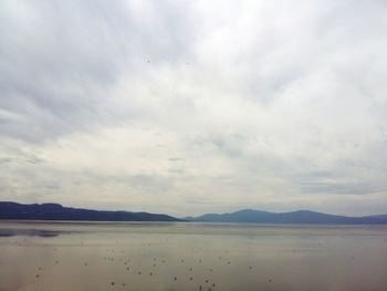 Scenic view of mountains against cloudy sky