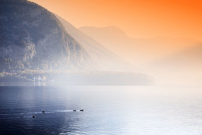 Scenic view of lake and mountains against sky