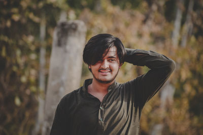 Portrait of young man standing outdoors