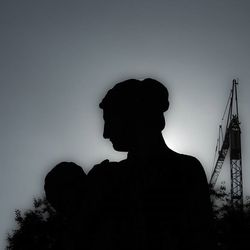 Low angle view of silhouette people against sky