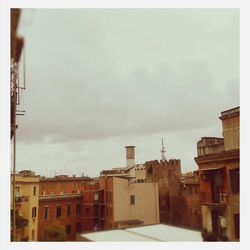 View of buildings against cloudy sky