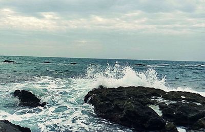 Scenic view of sea against cloudy sky