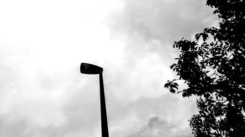 Low angle view of silhouette street light against sky