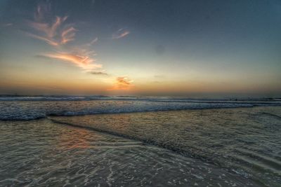 Scenic view of beach against sky during sunset