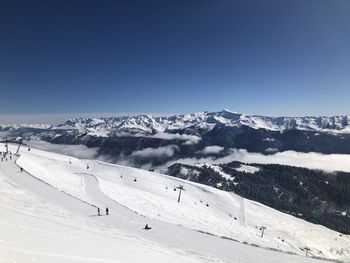 Scenic view of snowcapped mountains against clear blue sky