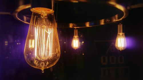 Close-up of light bulb at night