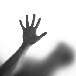 Close-up of hand holding over white background