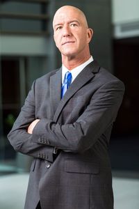 Portrait of businessman with arms crossed standing in office