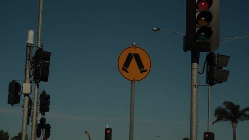 Low angle view of road sign against sky