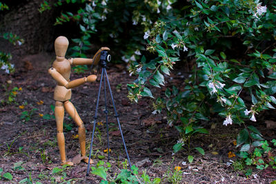 Photographer wooden mannequin with photo camera