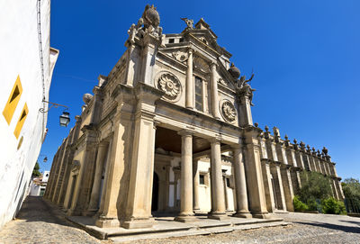 Low angle view of historical building against clear blue sky