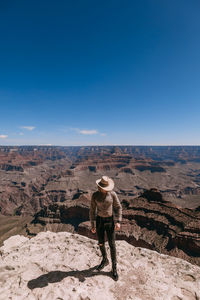 Full length of man standing on desert against sky