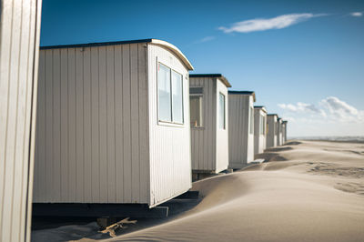 Built structures on beach against sky