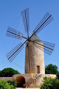 Low angle view of traditional windmill against sky