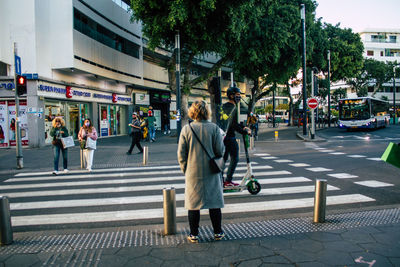 People walking on road in city