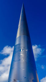 Low angle view of airplane against blue sky