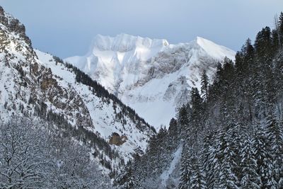 Scenic view of snow covered mountains against sky