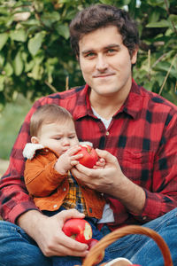 Portrait of father and son outdoors