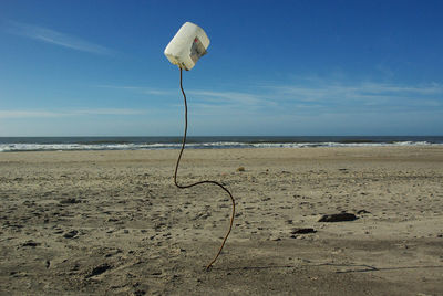 Scenic view of beach against blue sky