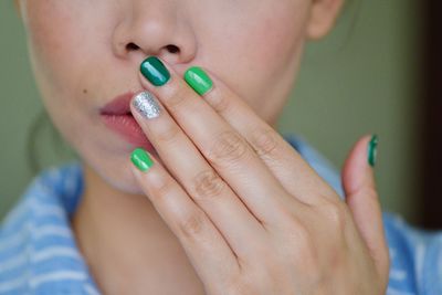 Close-up of woman with colorful nails