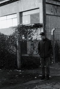 Rear view of man with umbrella walking on street