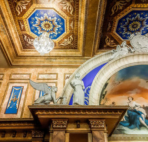 Low angle view of statues on ceiling of building