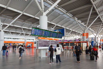 People walking on railroad station platform