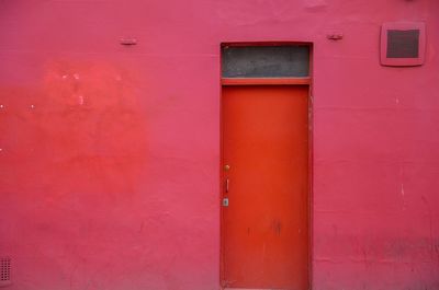 Close-up of closed red door of  red building