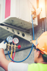 Worker looking at pressure gauge