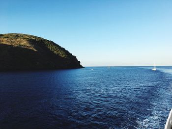 Scenic view of sea against clear blue sky