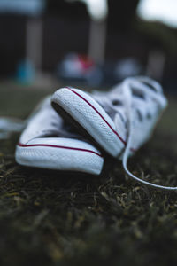 Close-up of shoes on grassy land