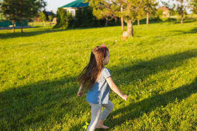 Side view of a girl on grassy field