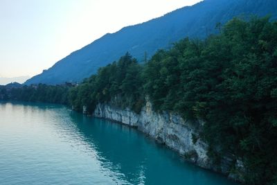 Scenic view of lake and mountains against clear sky