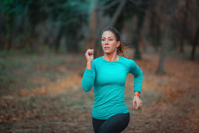 Woman running in forest