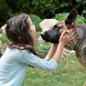 Close-up of young woman with dog