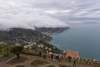 High angle view of townscape by sea against sky