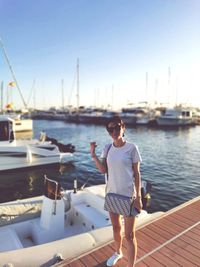 Full length of woman standing in sea against sky