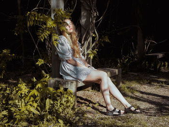 Woman sitting in forest