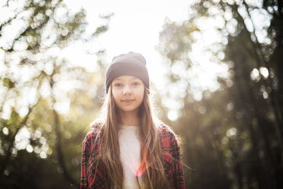 Portrait of girl standing in forest