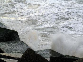 Waves splashing on rocks at shore