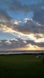 Scenic view of field against sky during sunset