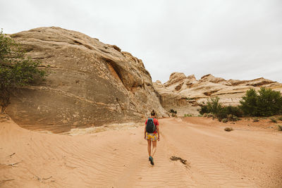 Rear view of women walking on rocks