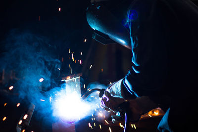 Welder welding in workshop