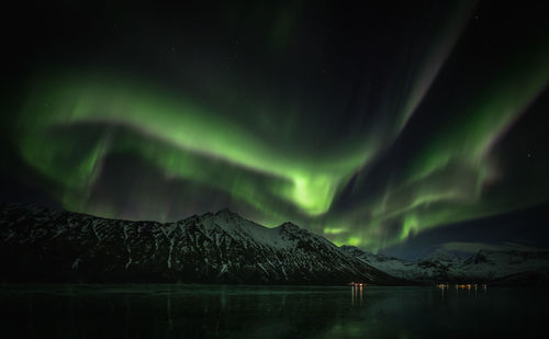 Scenic view of snowcapped mountains against sky at night