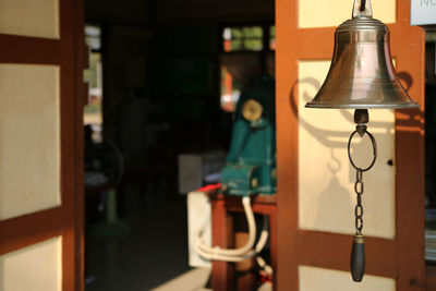 Close-up of bell hanging at home